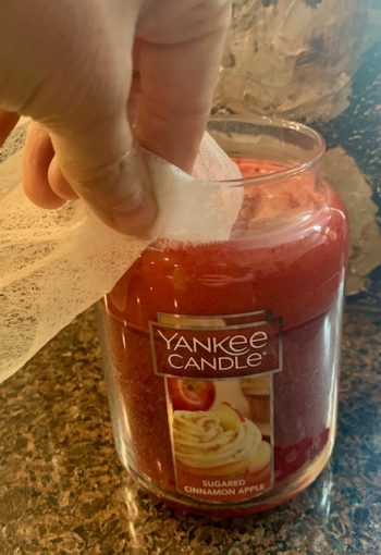 remove soot from candle jar with an old dryer sheet