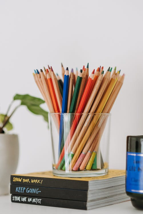 Colorful pencils in a glass jar - kids’ room organization