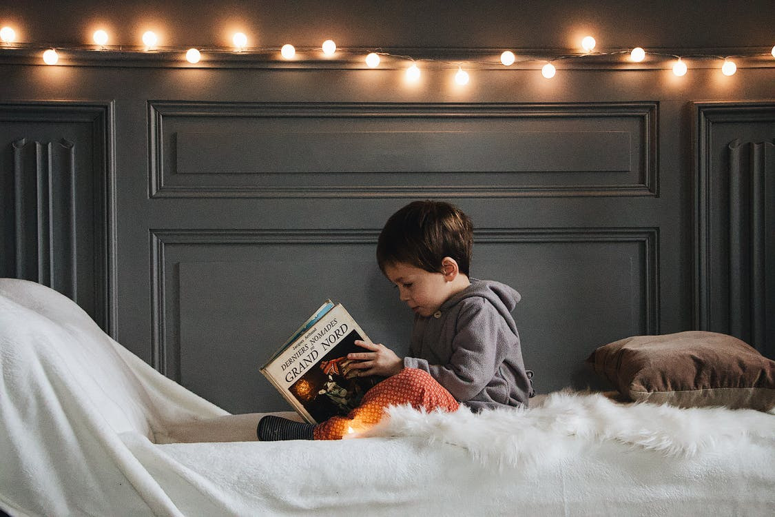 A kid reading in a corner